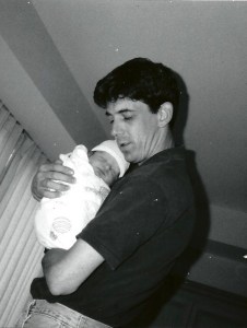 Black and white photo of dad holding baby Justin