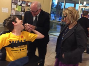 Justin shaking hands with Tim Walz with Peggy Flanagan smiling