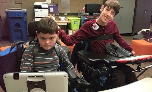 Roa using communication device, Justin smiling