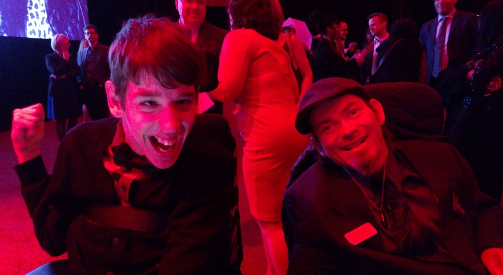 Justin and man using wheelchair at inaugural celebration