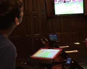 Justin watching tv in pub