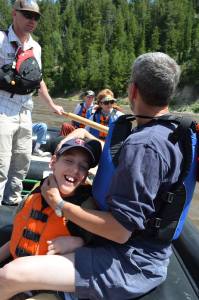 Justin and dad with group of people on float raft