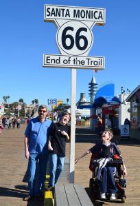Justin, dad and brother at Santa Monica End of the Trail sign