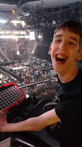 Justin smiling with concert crowd behind