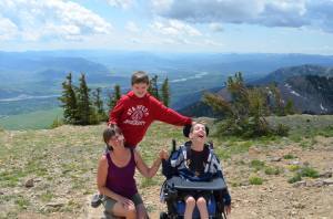 Justin with his mom and brother with mountains behind