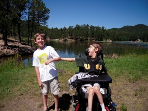 12 year old Justin with his brother with lake behind