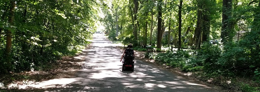 Wheelchair driving away on road