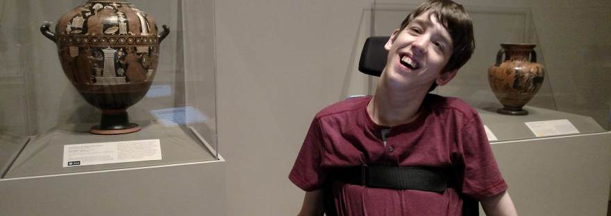 Justin smiling in front of ancient Greek vases