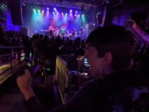 Justin looking across main floor crowd at 26 BATS! on First Avenue stage