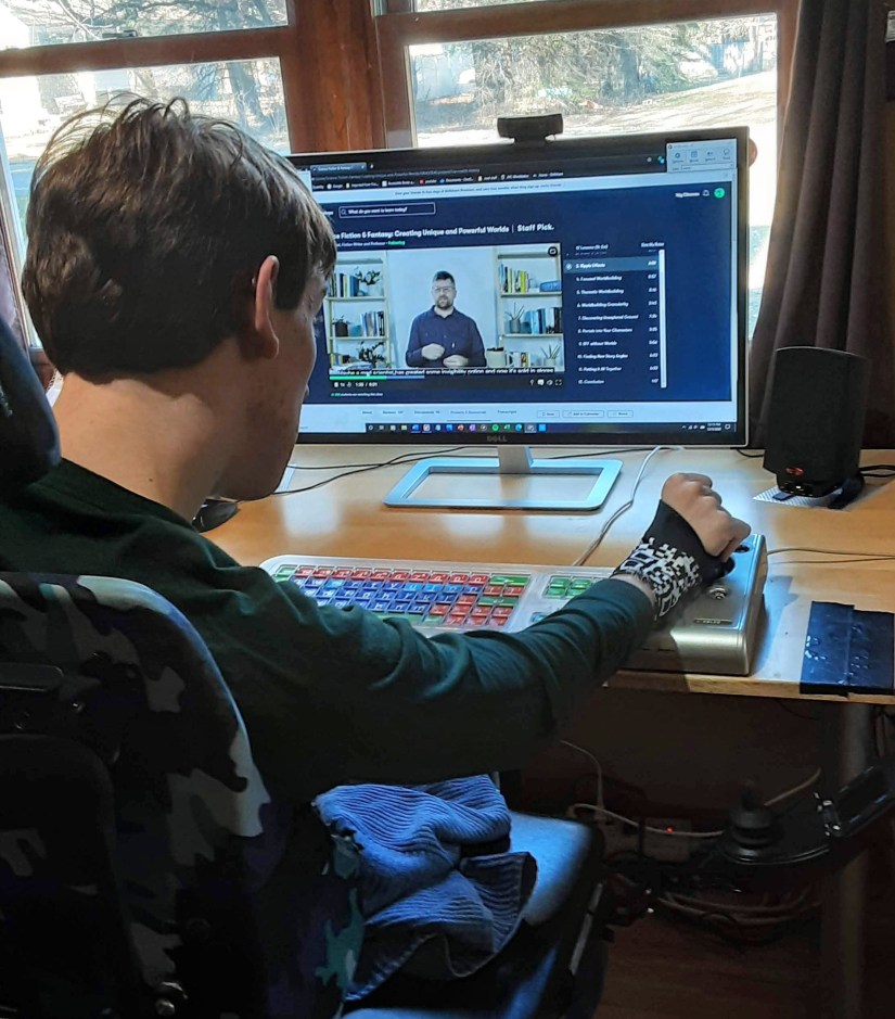 Justin looking at Skillshare course on computer monitor