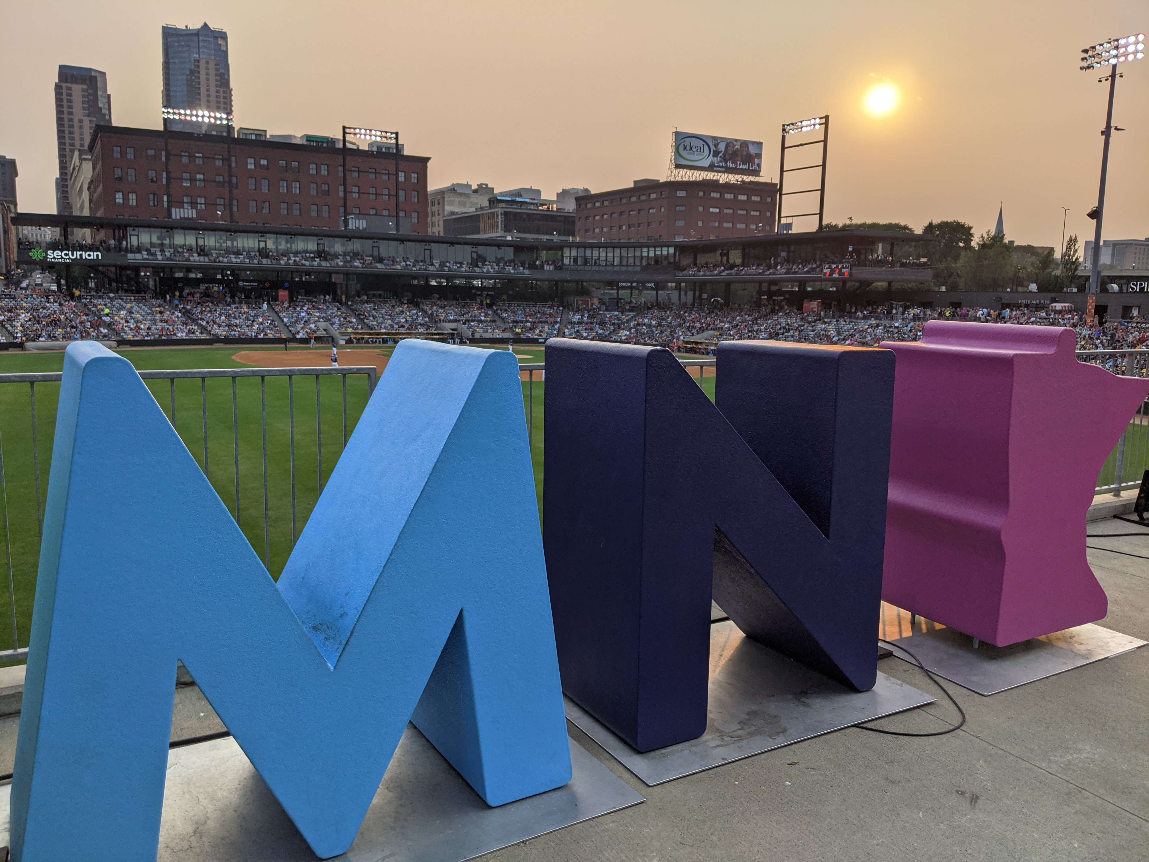 MN sculpture letters overlooking CHS baseball field, sunset, St. Paul skyline