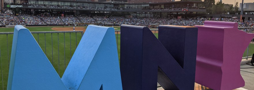 MN sculpture letters overlooking CHS baseball field, sunset, St. Paul skyline