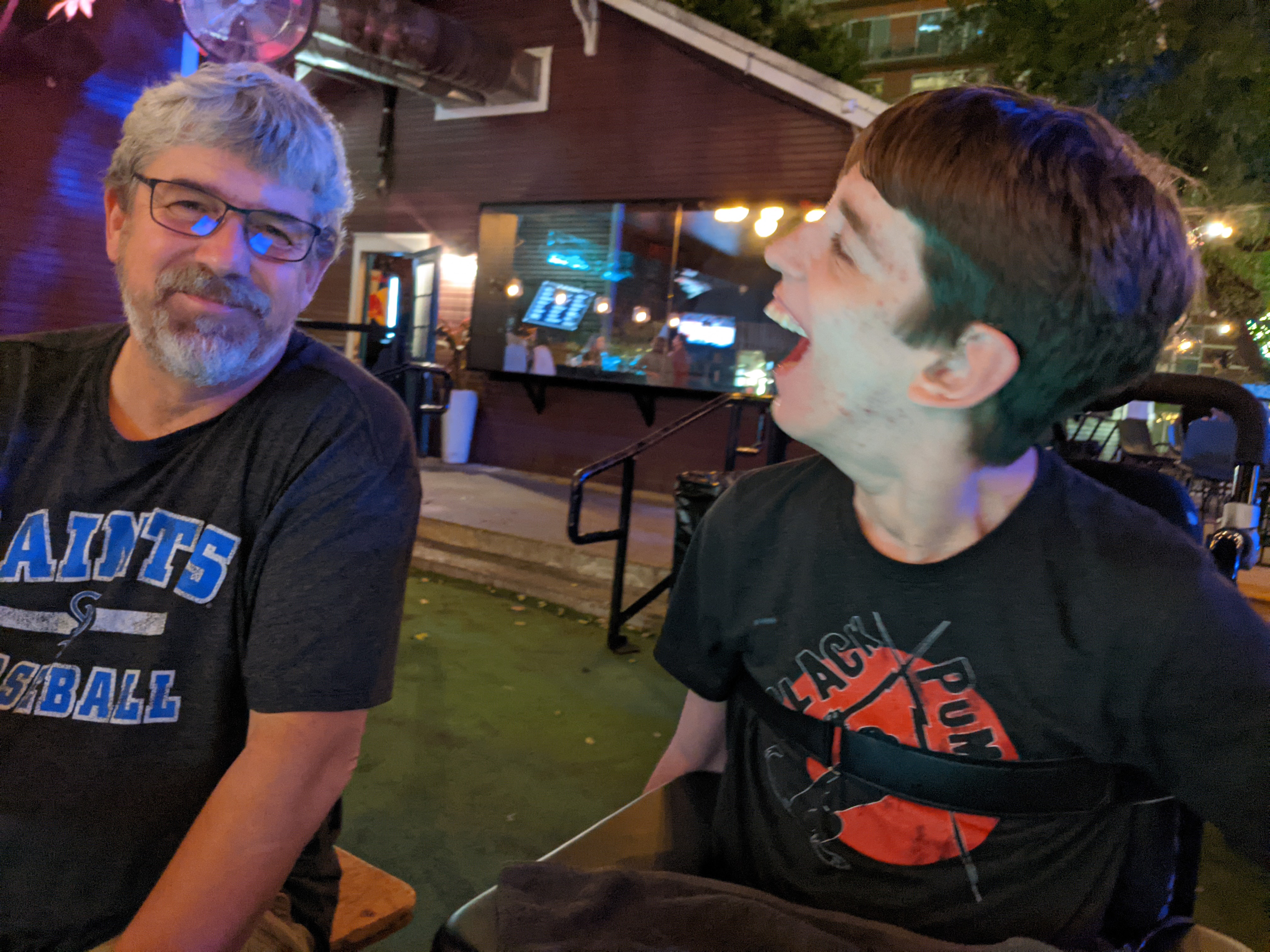 Justin sitting with his dad outside at bar