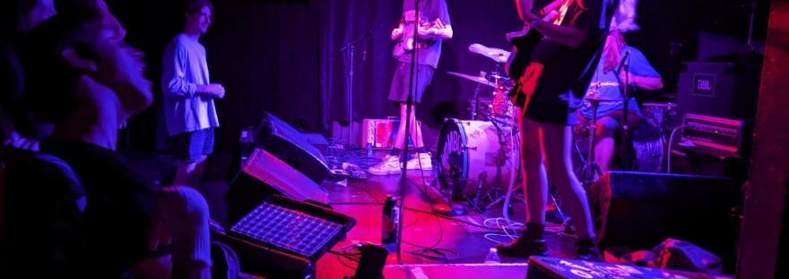 Wombo band on 7th street entry stage, Justin in wheelchair watching band