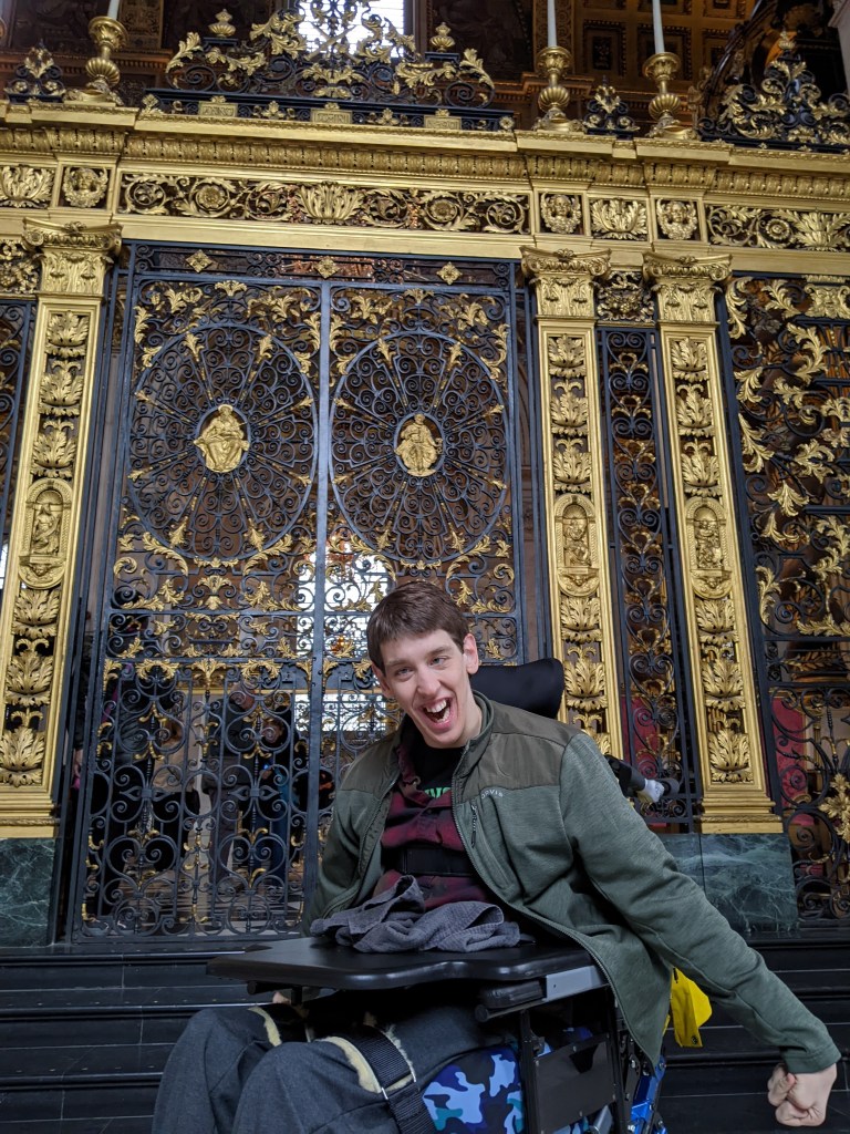 Justin in wheelchair in front of ornate gate, st. Paul's cathedral