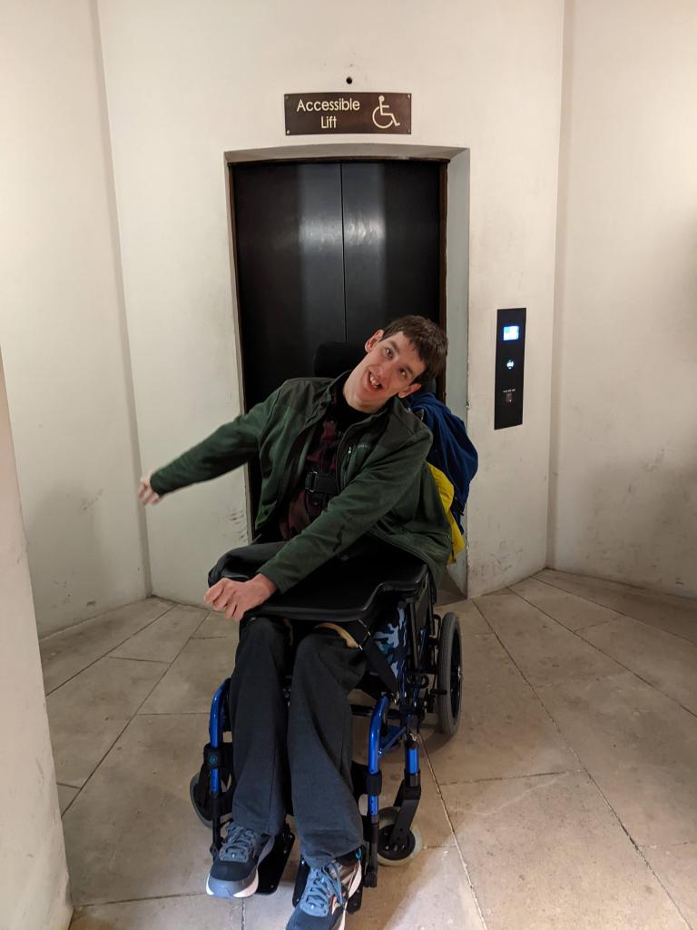 Justin in front of accessible lift