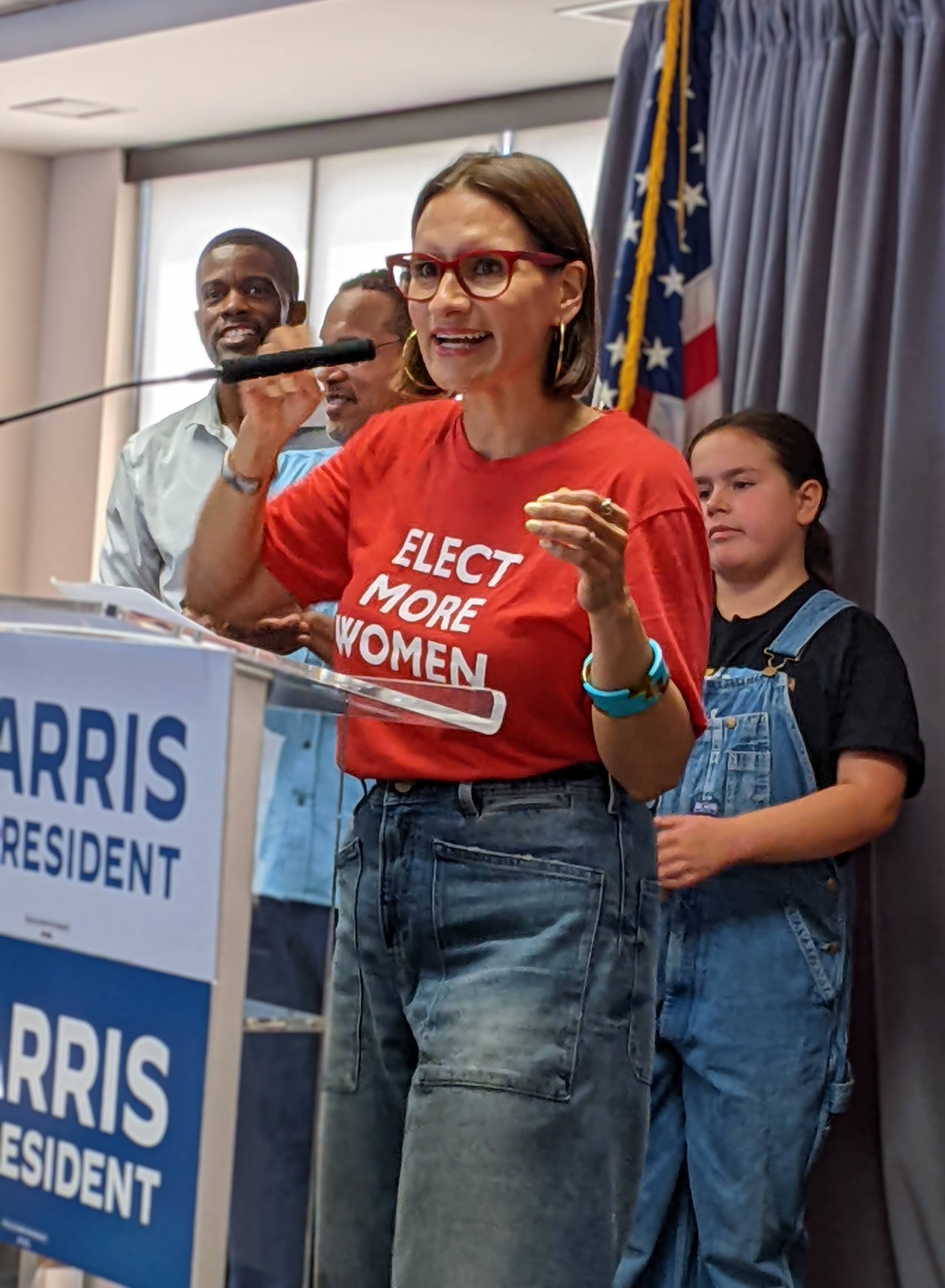 MN Lieutenant Governor Peggy Flanagan speaking at microphone wearing elect more women t-shirt