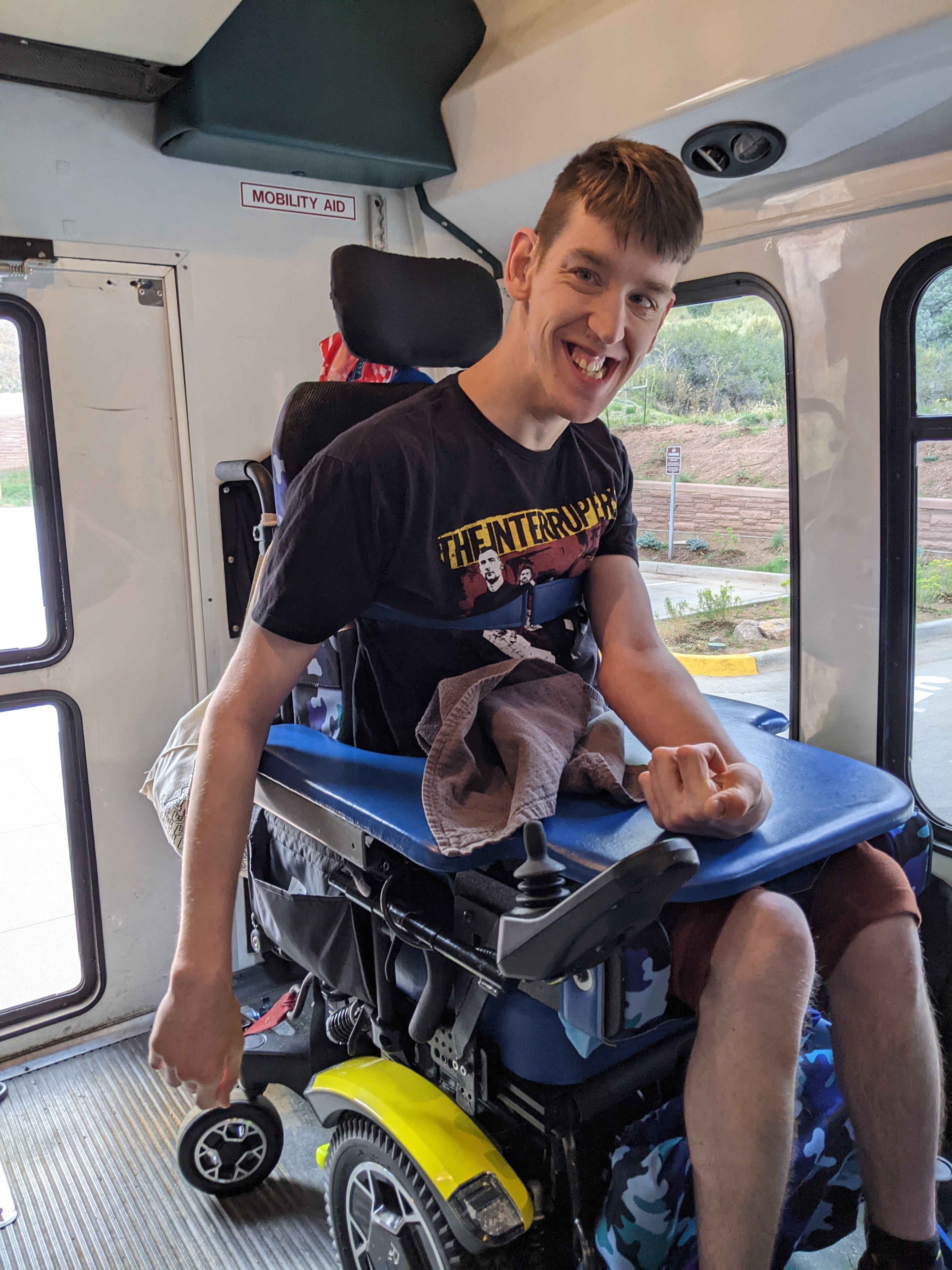 Justin, young man in power wheelchair in shuttle van