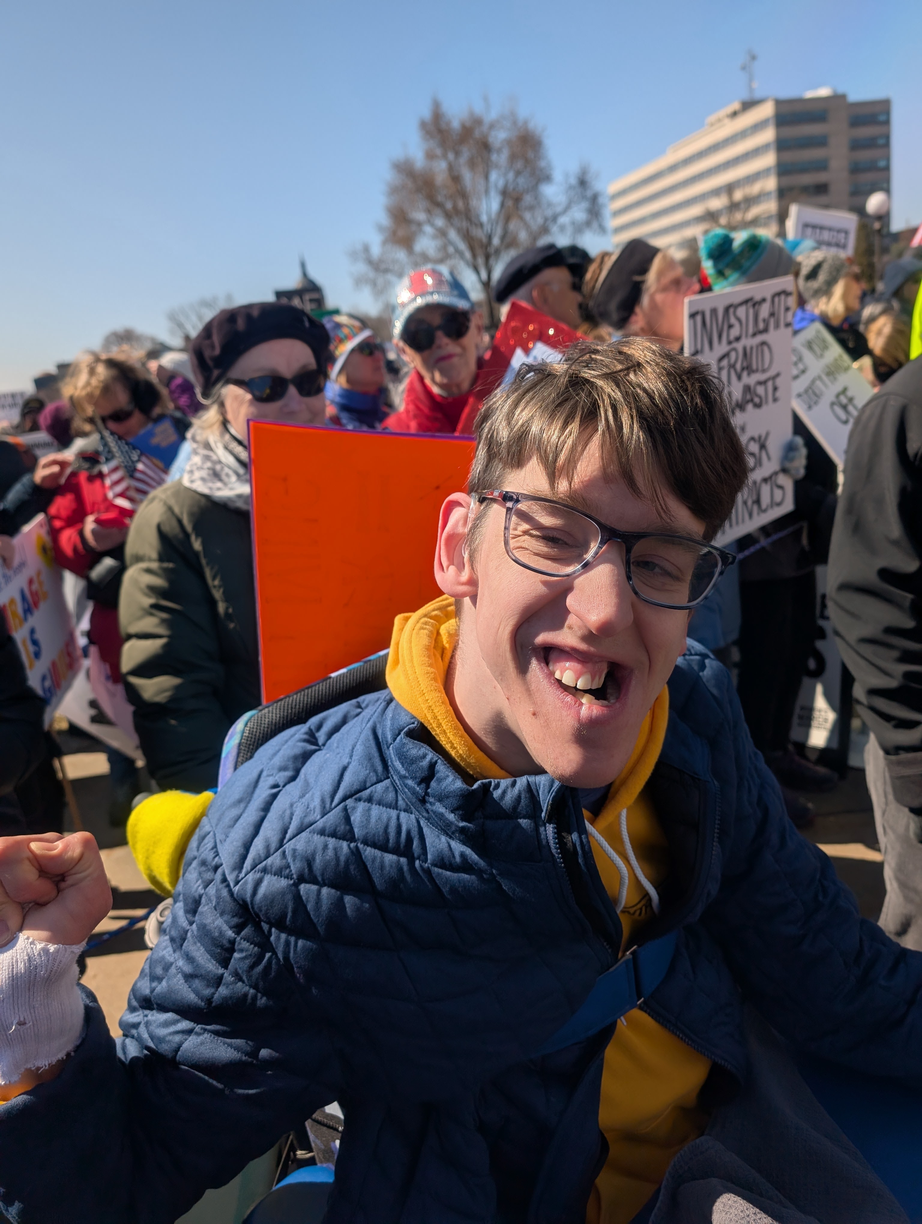 Justin smiling with winter jacket on in crowd