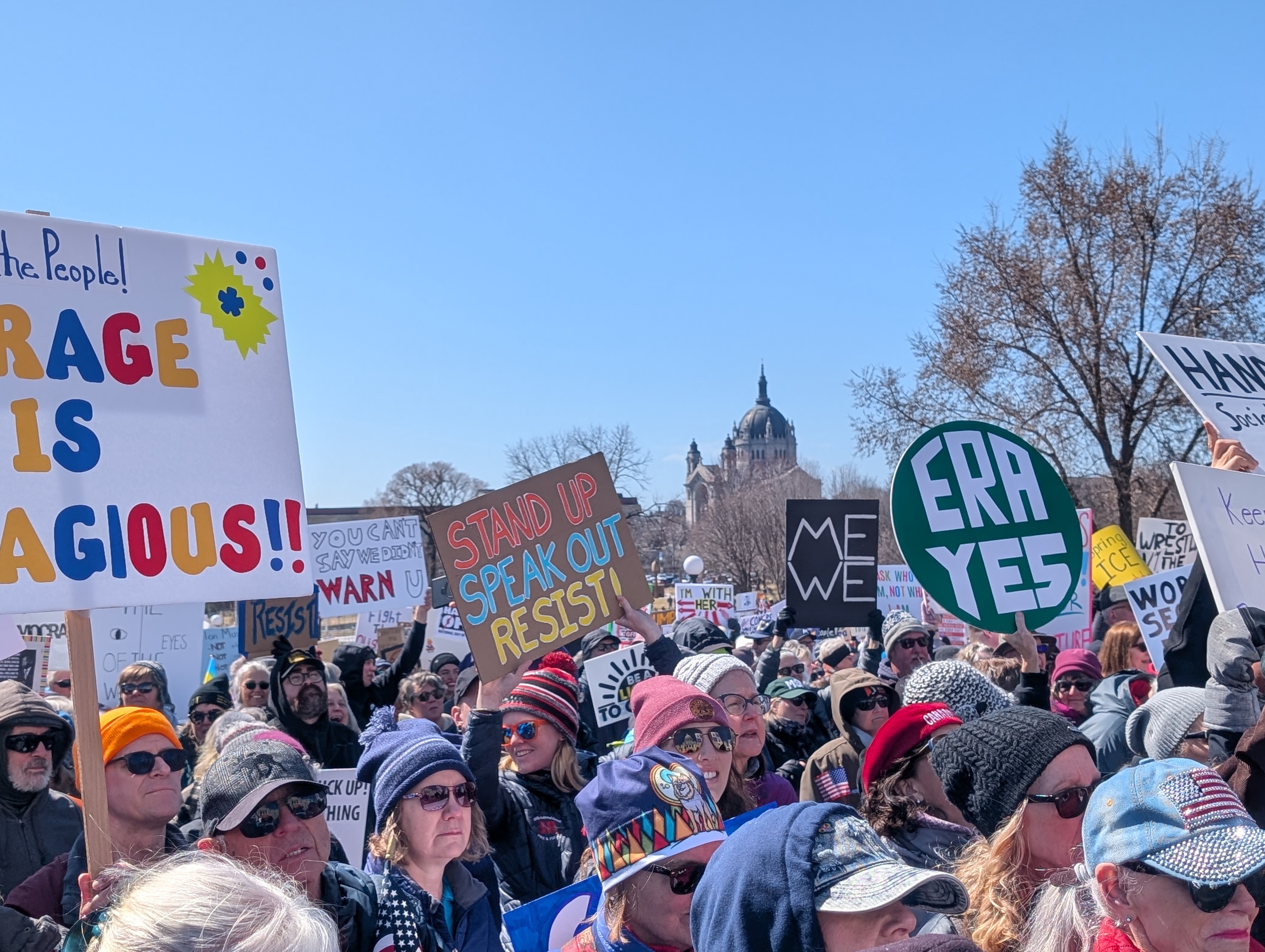 Crowd with signs, St. Paul Cathedral in distance