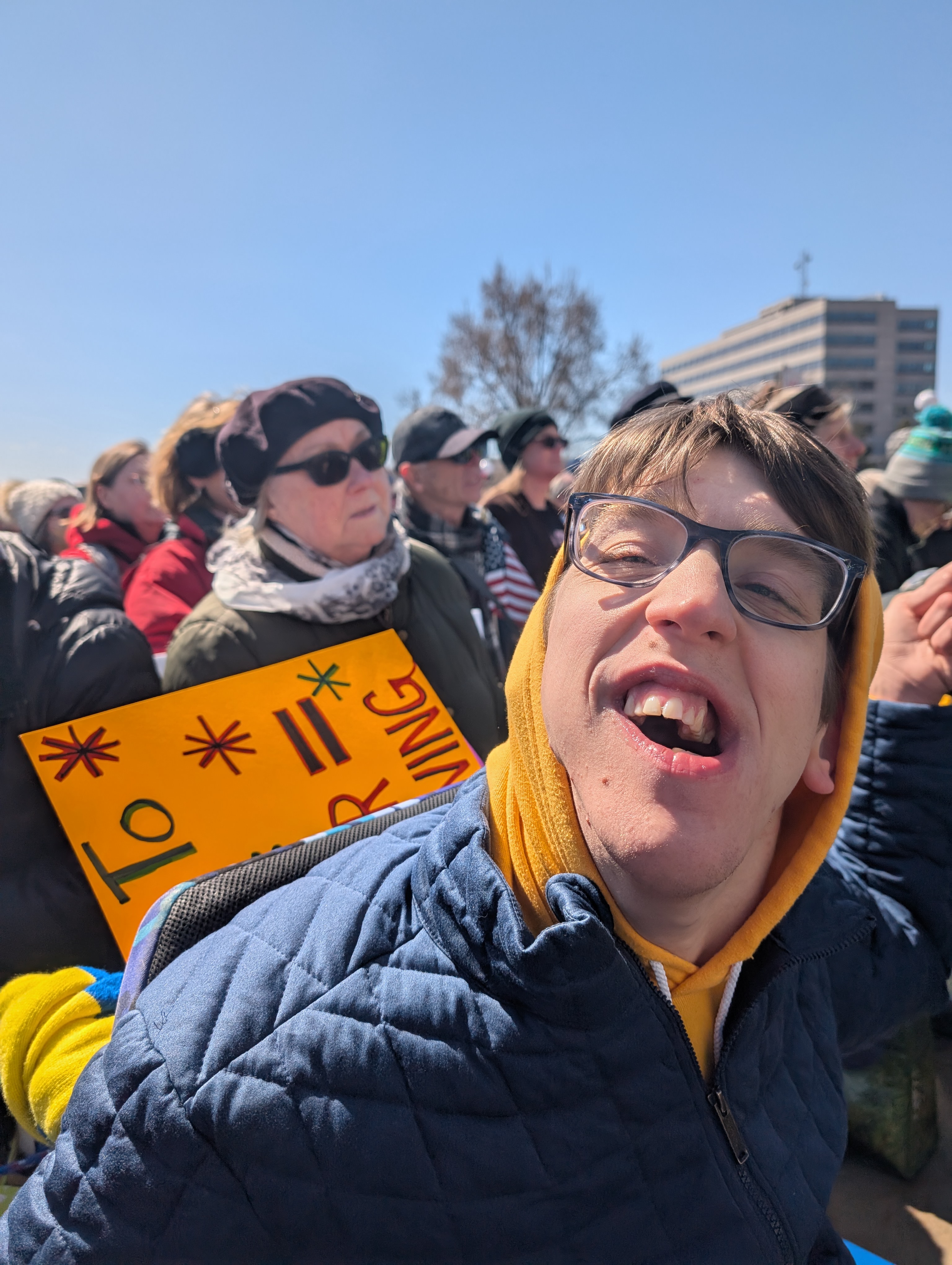 Justin with sweatshirt hood up in crowd