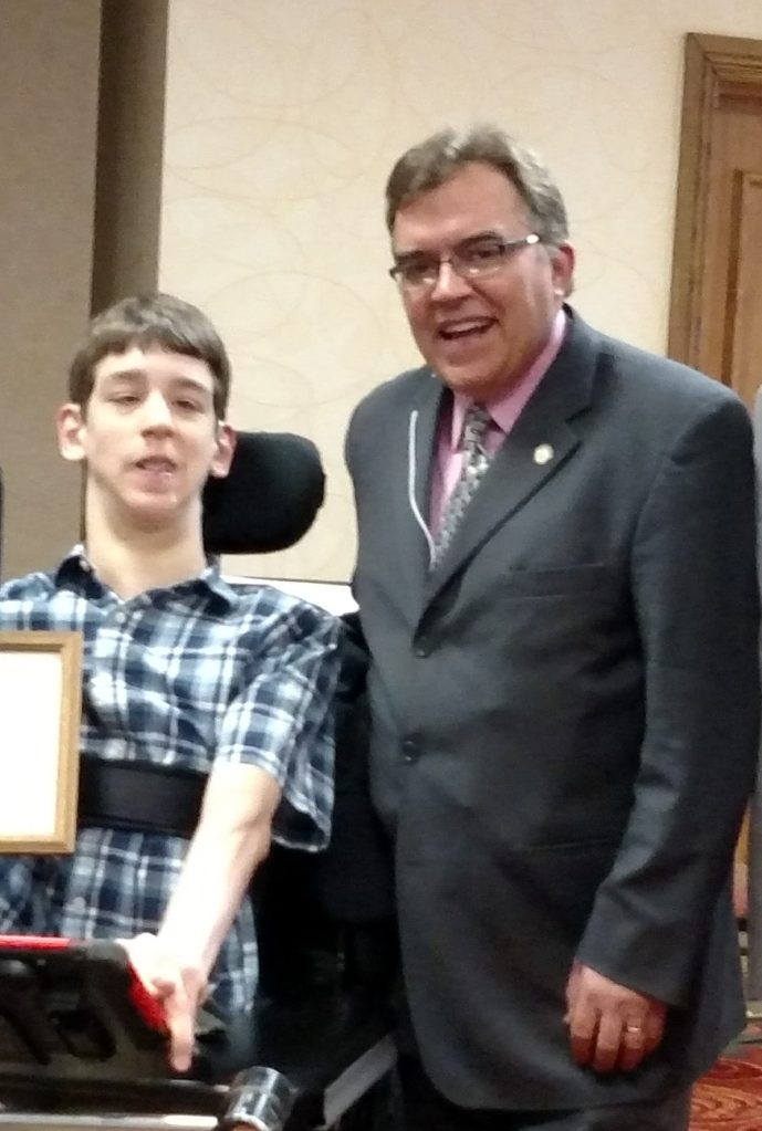 18-year old young man in wheelchair with smiling Senator John Hoffman