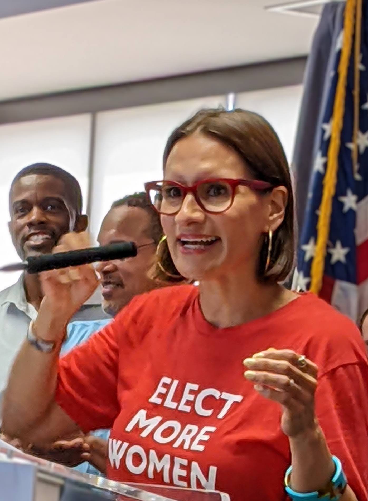 MN Lieutenant Governor Peggy Flanagan speaking at microphone wearing elect more women t-shirt
