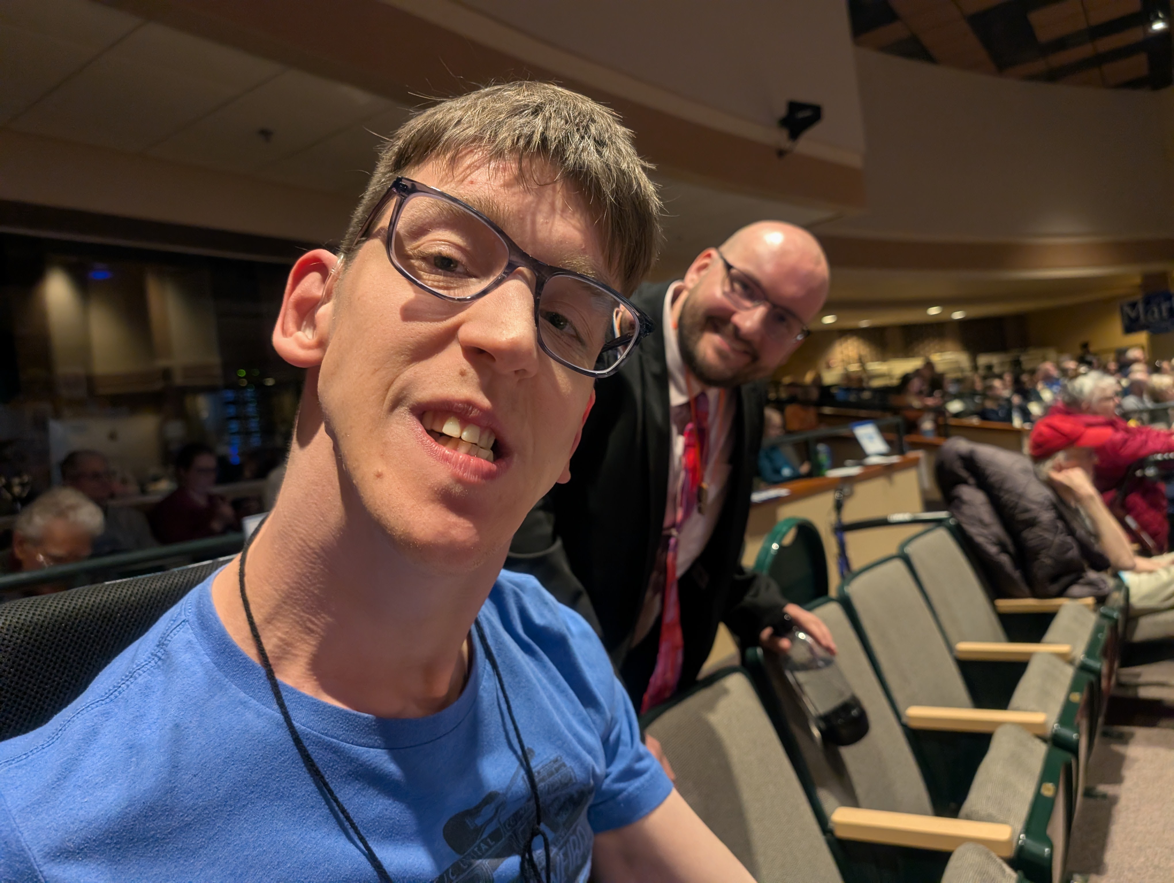 Justin and David Gottfried in auditorium smiling at camera